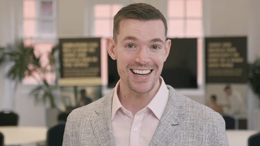 Guest speaker presenting at a business event, captured in a promotional highlight video.