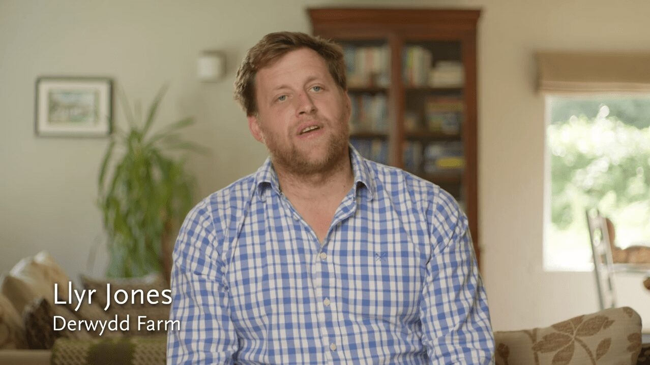 An image of the farmer in his farmhouse explaining his passion on film.