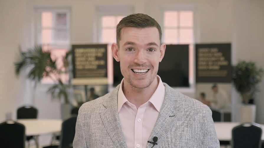 Networking scene at a corporate event, used in a video to attract future attendees and clients.